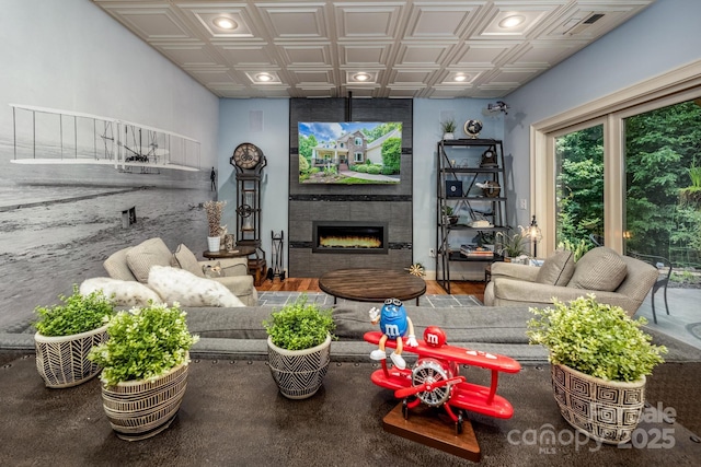 living room featuring hardwood / wood-style flooring and a tile fireplace