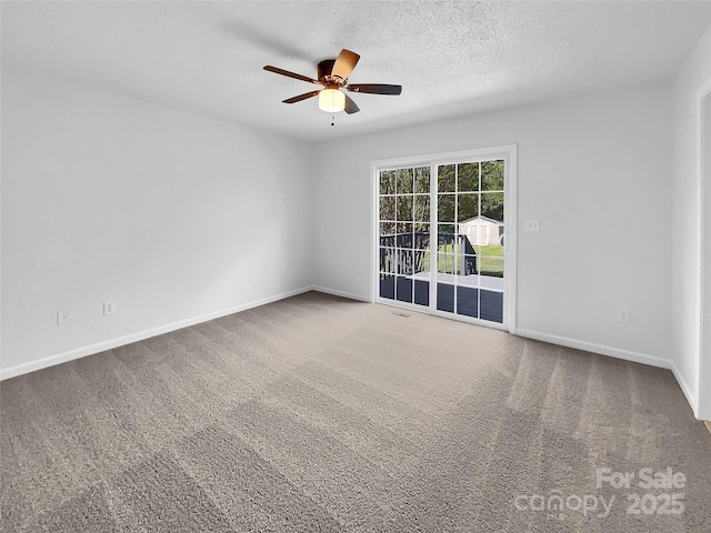 carpeted spare room featuring ceiling fan and a textured ceiling