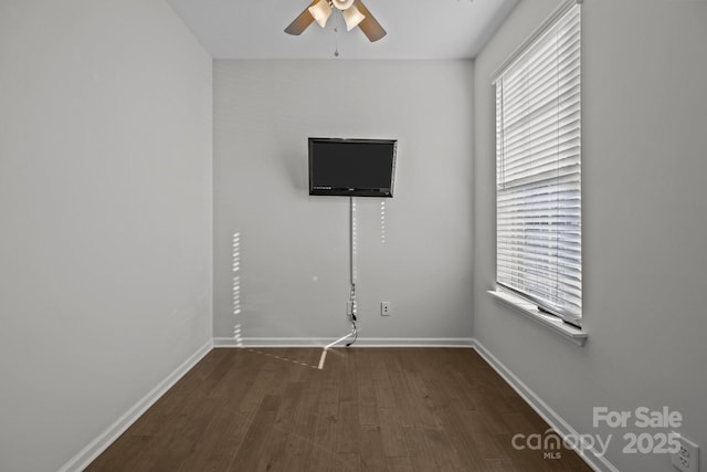 unfurnished room with dark wood-type flooring and ceiling fan