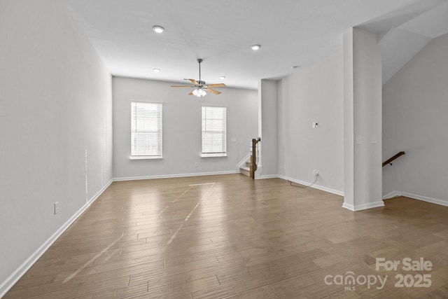 unfurnished living room featuring hardwood / wood-style flooring and ceiling fan