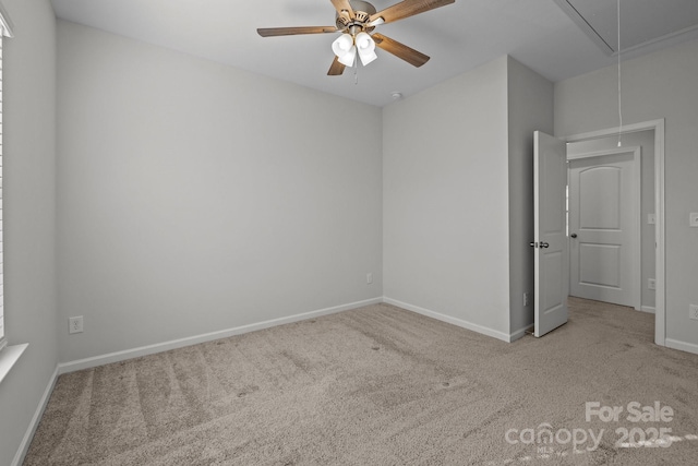 spare room with ceiling fan and light carpet