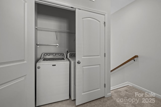 laundry area featuring light carpet and washer and clothes dryer