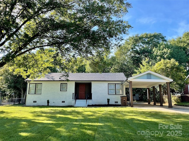 rear view of house featuring a yard and a carport