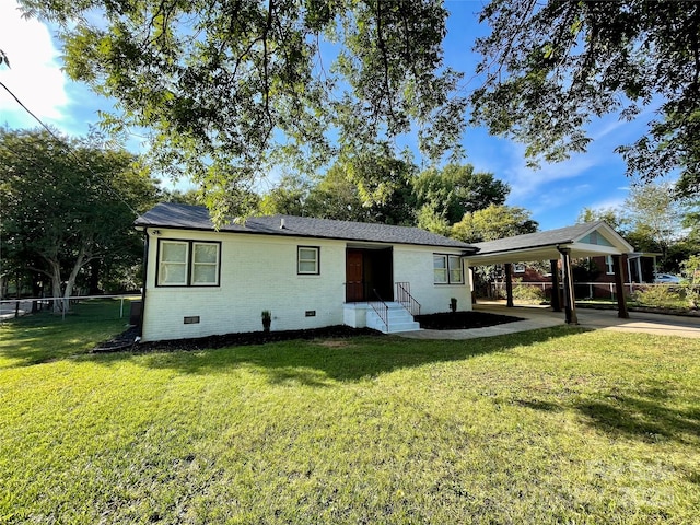 rear view of property featuring a yard and a carport