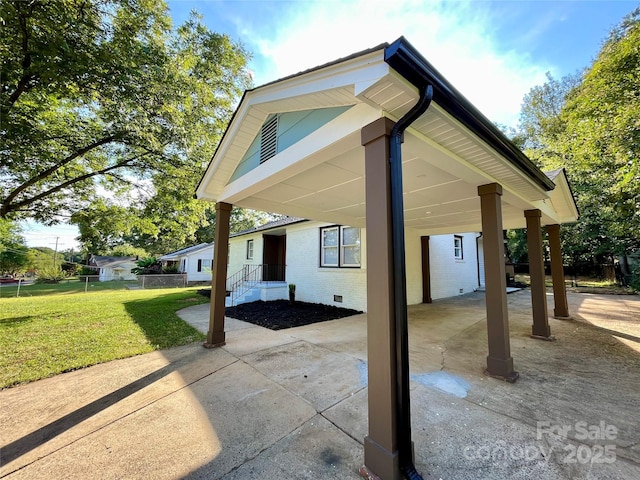 view of property exterior featuring a yard and a carport