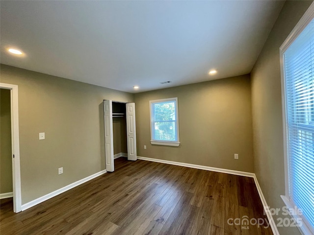 unfurnished bedroom with dark hardwood / wood-style floors