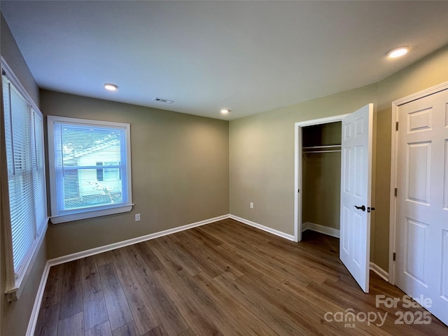 unfurnished bedroom with dark hardwood / wood-style floors