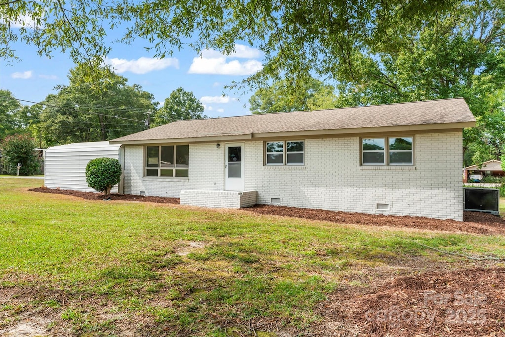 ranch-style house with a front lawn