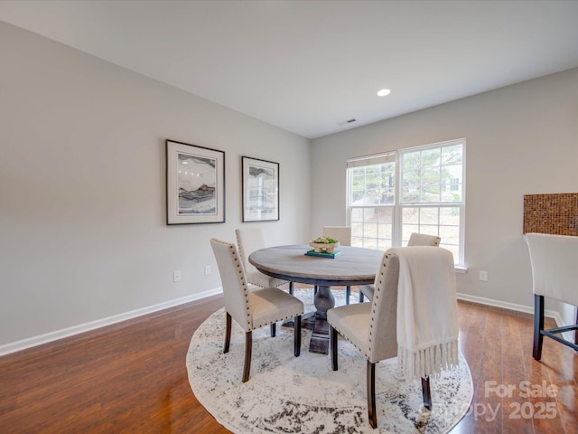 dining room with dark wood-type flooring