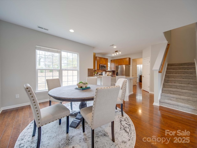 dining room with sink and light hardwood / wood-style flooring