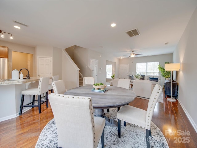 dining space with hardwood / wood-style flooring and ceiling fan