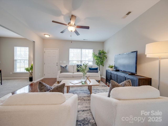 living room featuring hardwood / wood-style floors and ceiling fan