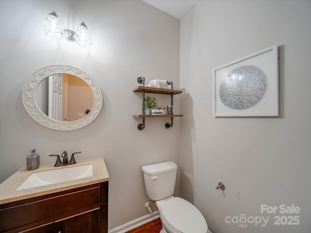 bathroom with toilet and vanity