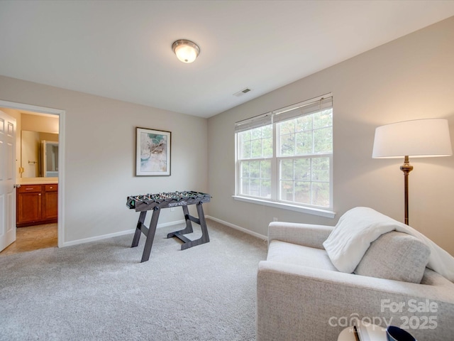 sitting room featuring light carpet