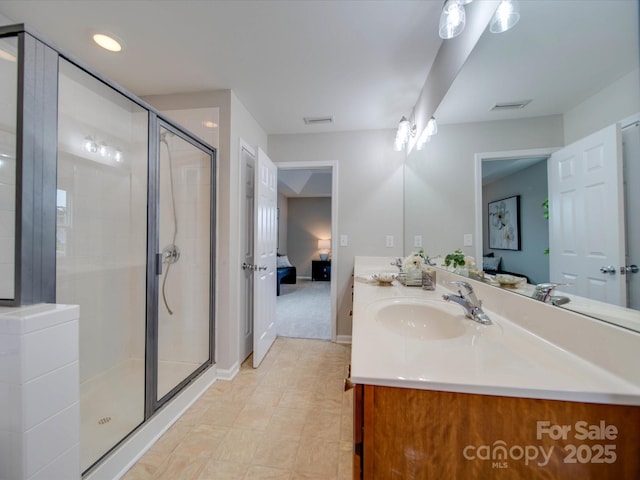 bathroom featuring a shower with shower door and vanity