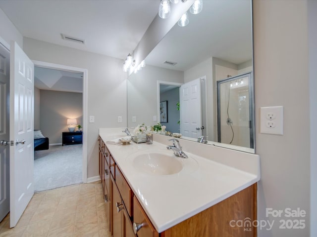 bathroom with a shower with shower door and vanity