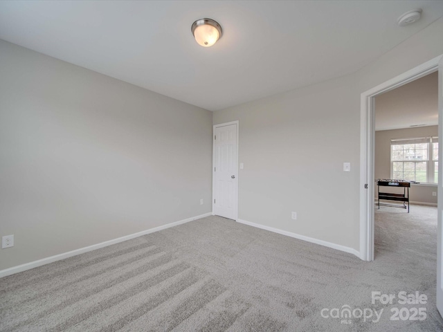 unfurnished room with light carpet