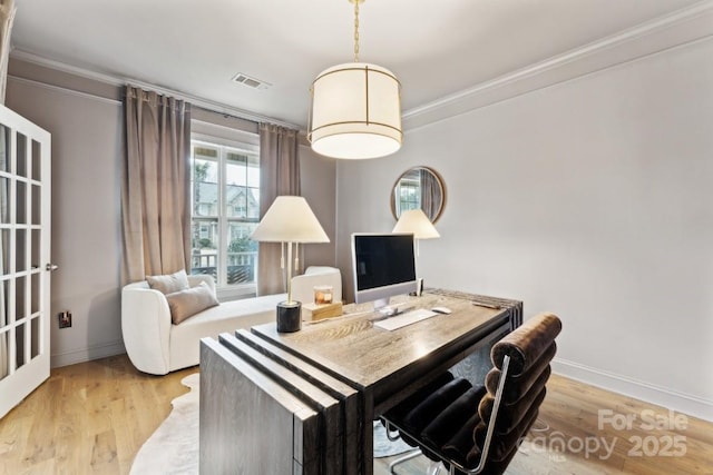 office space featuring ornamental molding, light wood-type flooring, visible vents, and baseboards