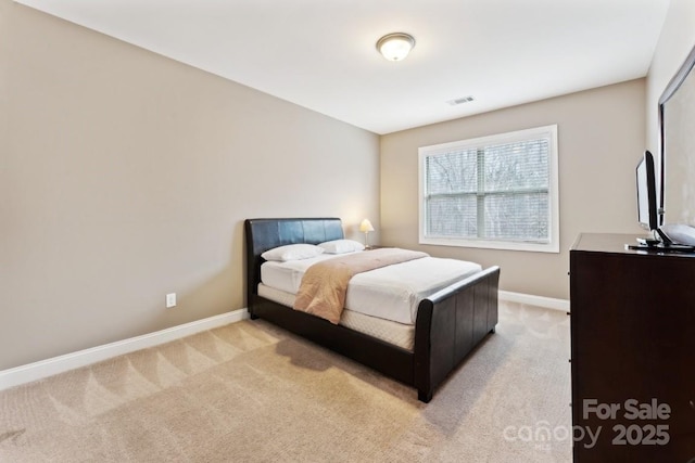 bedroom featuring light carpet, visible vents, and baseboards