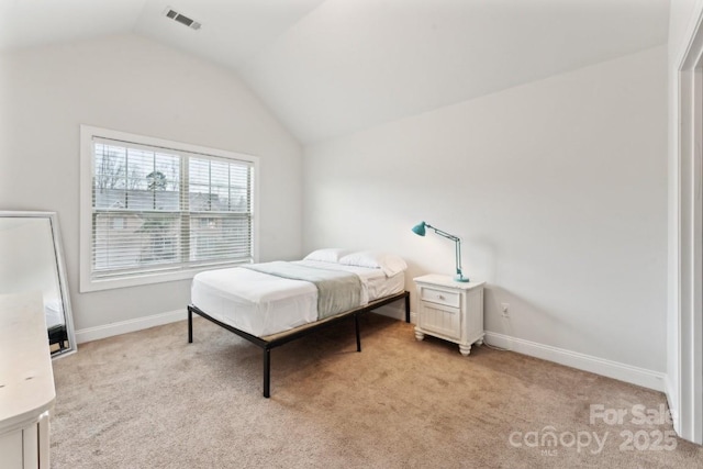 bedroom with light carpet, vaulted ceiling, visible vents, and baseboards