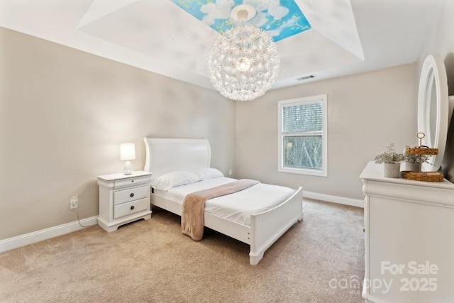 bedroom featuring baseboards, visible vents, a tray ceiling, and light colored carpet