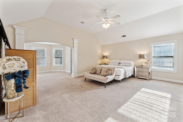 bedroom with arched walkways, visible vents, light carpet, vaulted ceiling, and baseboards