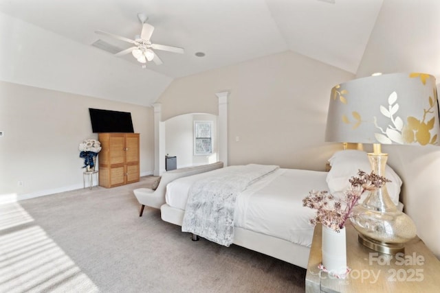 carpeted bedroom with a ceiling fan, lofted ceiling, arched walkways, and baseboards