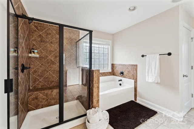 bathroom featuring a shower stall, baseboards, and a bath