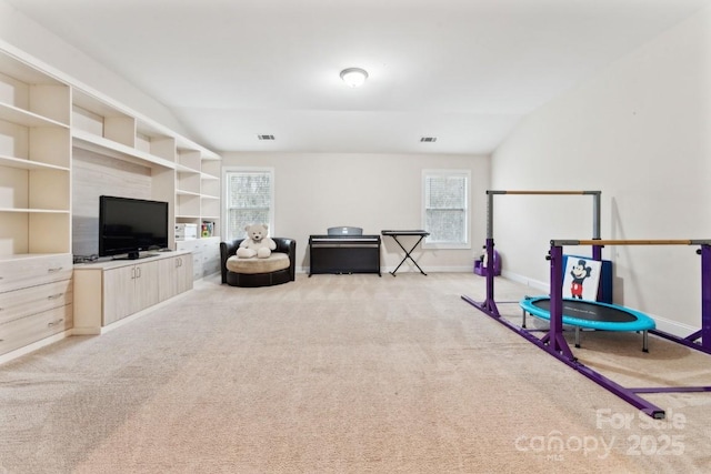 game room featuring light carpet, visible vents, baseboards, and vaulted ceiling