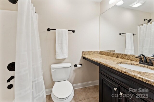 bathroom with toilet, tile patterned flooring, baseboards, and vanity