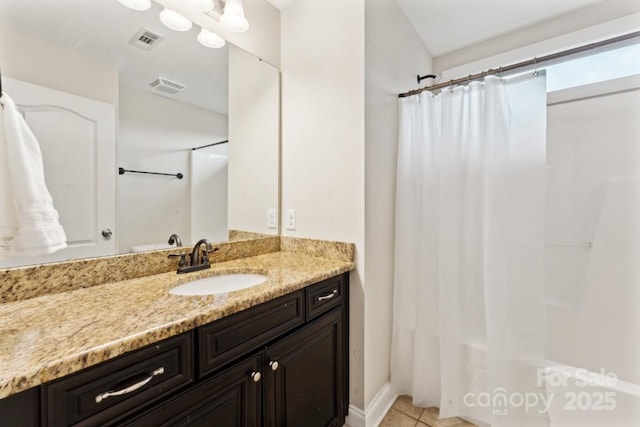 bathroom featuring a shower with shower curtain, tile patterned flooring, visible vents, and vanity