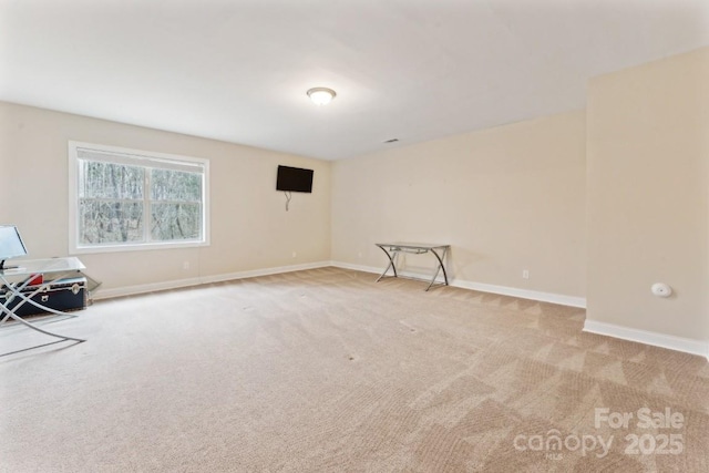 interior space featuring light carpet and baseboards