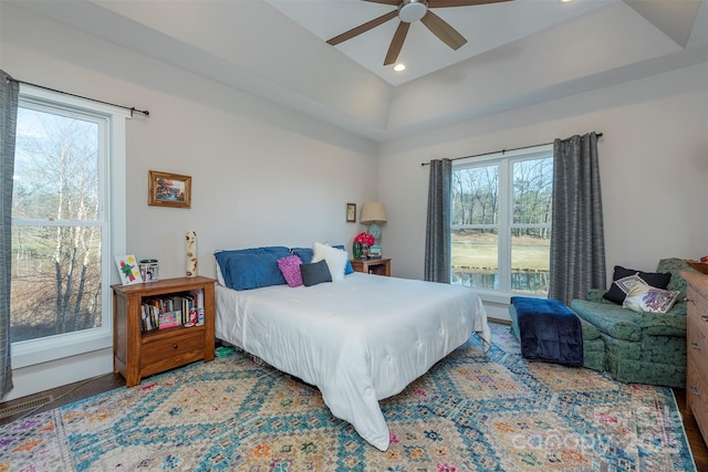 bedroom with ceiling fan and multiple windows