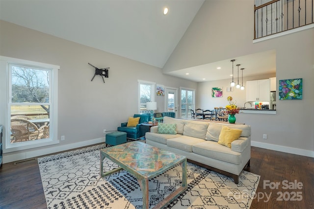 living room featuring hardwood / wood-style flooring and high vaulted ceiling