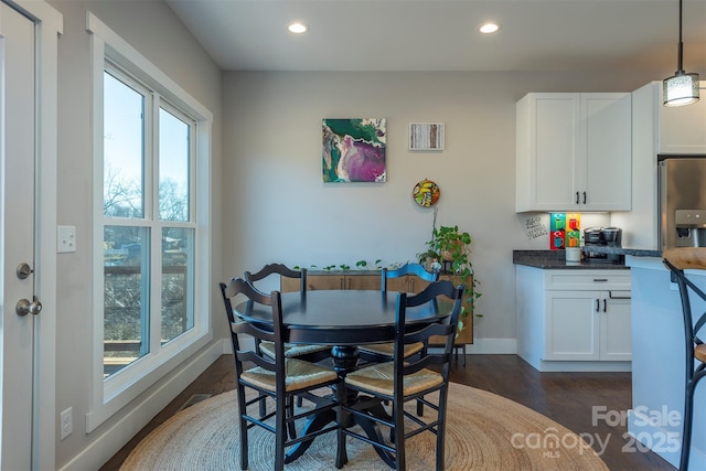 dining area with dark hardwood / wood-style floors