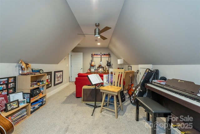 interior space featuring vaulted ceiling, light colored carpet, and ceiling fan