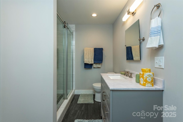 bathroom with hardwood / wood-style flooring, vanity, toilet, and an enclosed shower