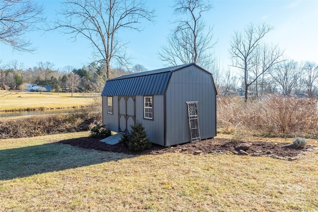 view of outdoor structure with a lawn and a rural view