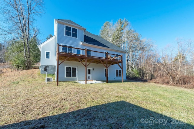 rear view of property featuring a deck and a lawn