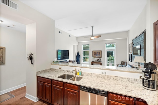 kitchen with dishwasher, light hardwood / wood-style floors, sink, kitchen peninsula, and light stone counters