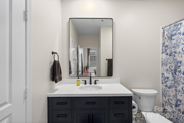 bathroom featuring vanity, toilet, and a shower with shower curtain