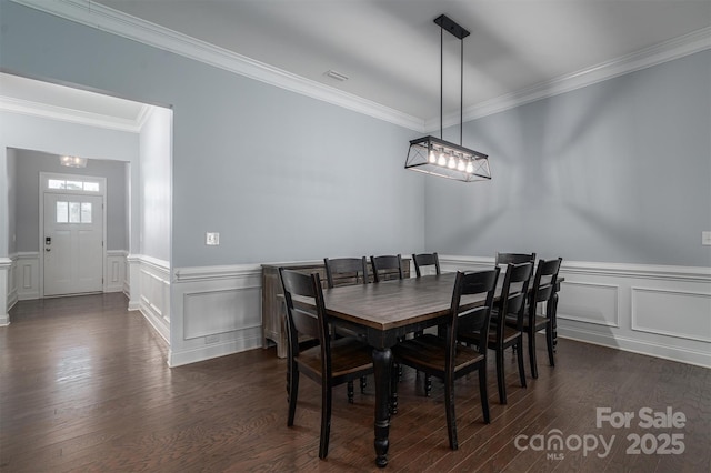 dining room featuring crown molding and dark hardwood / wood-style flooring