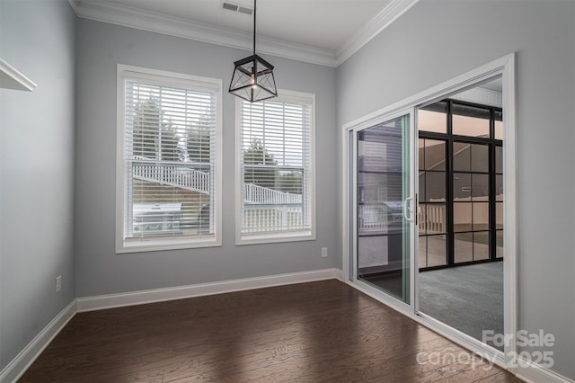 unfurnished dining area featuring dark hardwood / wood-style flooring and ornamental molding