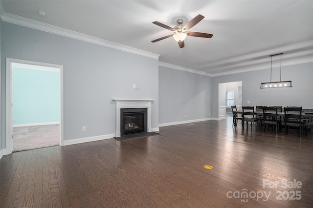 unfurnished living room with ceiling fan, dark hardwood / wood-style flooring, and ornamental molding