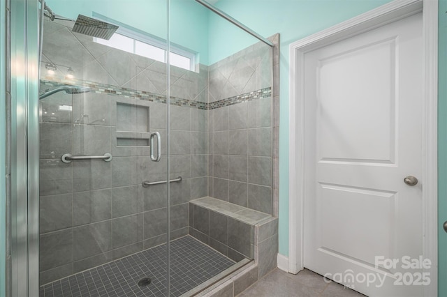 bathroom with walk in shower and tile patterned flooring