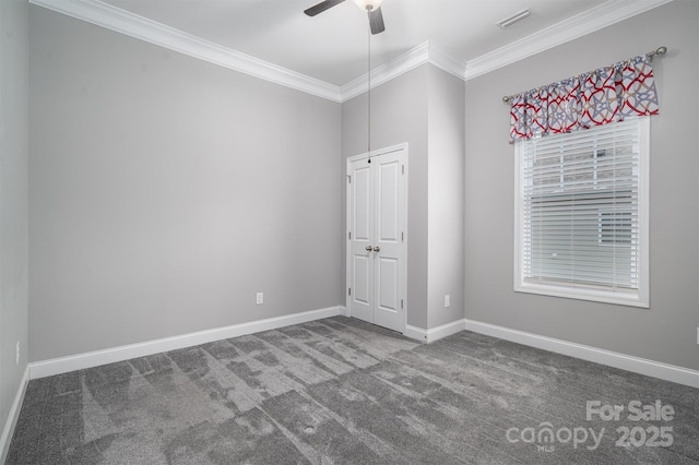 empty room featuring ceiling fan, carpet, and ornamental molding