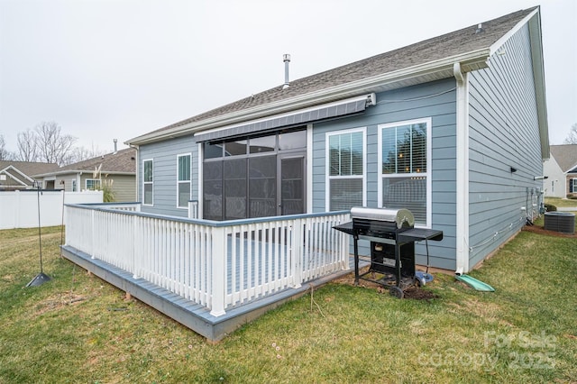 rear view of house with a wooden deck, a yard, and central air condition unit