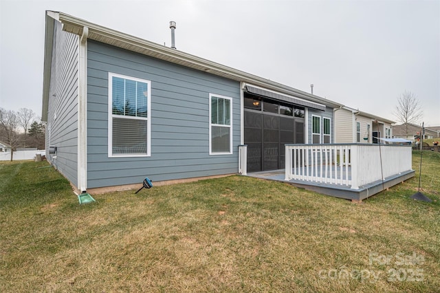 rear view of property featuring a lawn