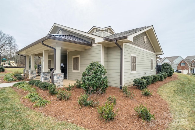 view of front of home with a porch and a front lawn