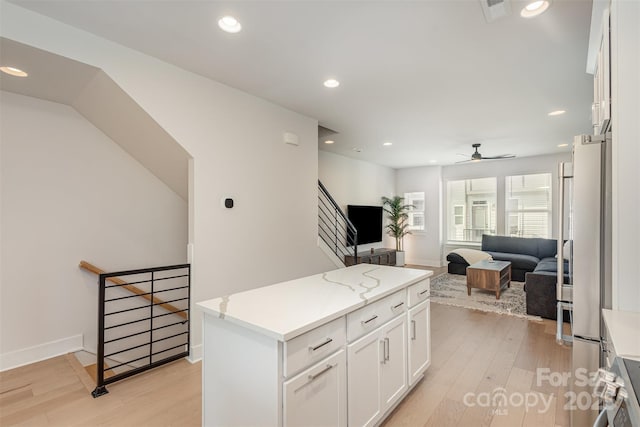 5048 York Park Ln, Charlotte, NC 28217 - kitchen with open floor plan, light wood finished floors, ceiling fan, visible vents, and appliances with stainless steel finishes